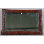 An early 20th century mahogany framed mirror with bead and reel mouldings, 117cm x 72cm.Buyer’s