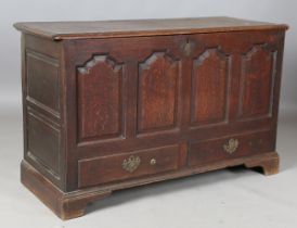 A late George III Lancastrian oak mule chest, the hinged lid above four arched panels and two