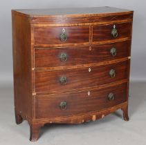 A George IV mahogany bowfront chest of drawers with pressed brass handle plates and inlaid bone