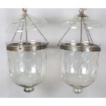 A pair of large early 20th century clear glass bell jar ceiling lights, each body etched overall