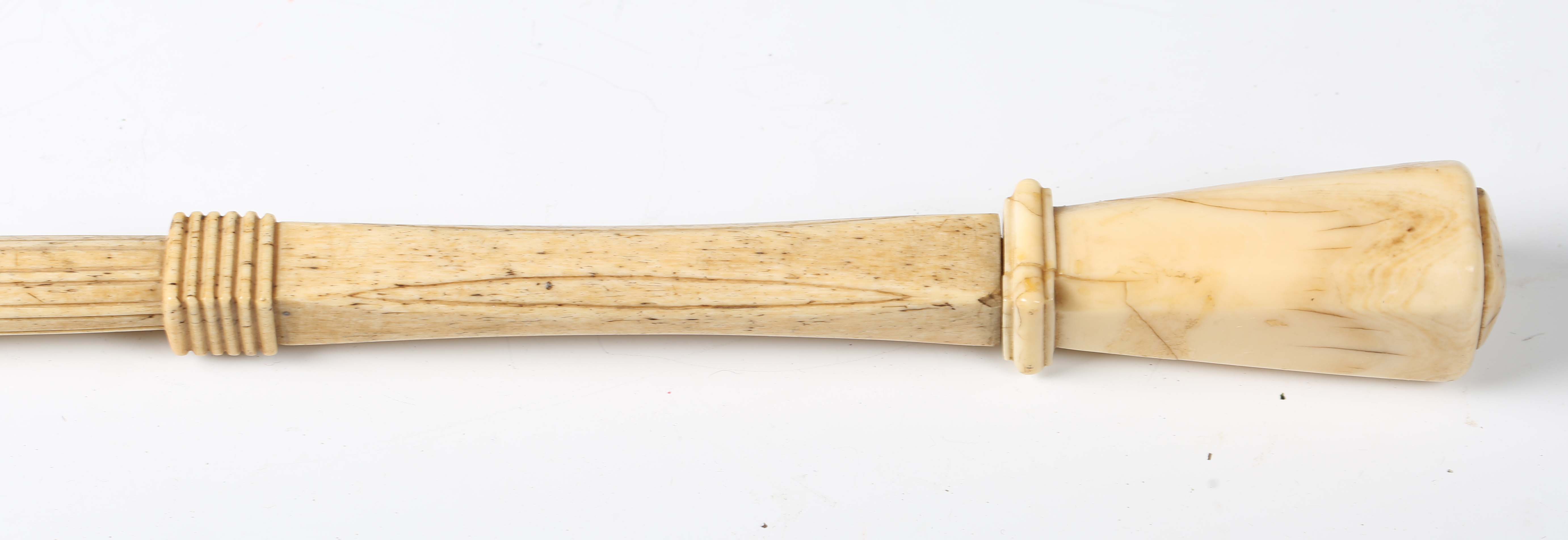 A late 18th/early 19th century carved scrimshaw walking cane, the marine ivory pommel above a carved