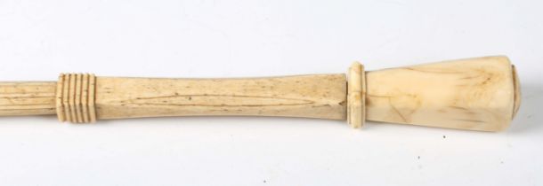 A late 18th/early 19th century carved scrimshaw walking cane, the marine ivory pommel above a carved