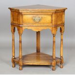 A modern reproduction oak corner table, fitted with a single frieze drawer, height 76cm, width 72cm,