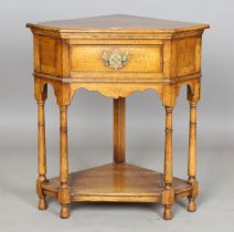 A modern reproduction oak corner table, fitted with a single frieze drawer, height 76cm, width 72cm,