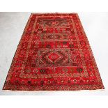 A Kurdi carpet, North-east Persia, late 20th century, the red field with three rectangular reserves,