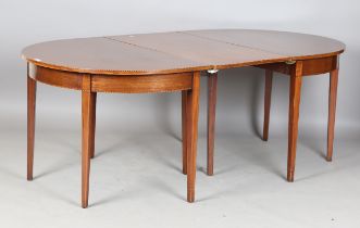 A George III and later mahogany dining table, the top with chequer banded edge and single extra