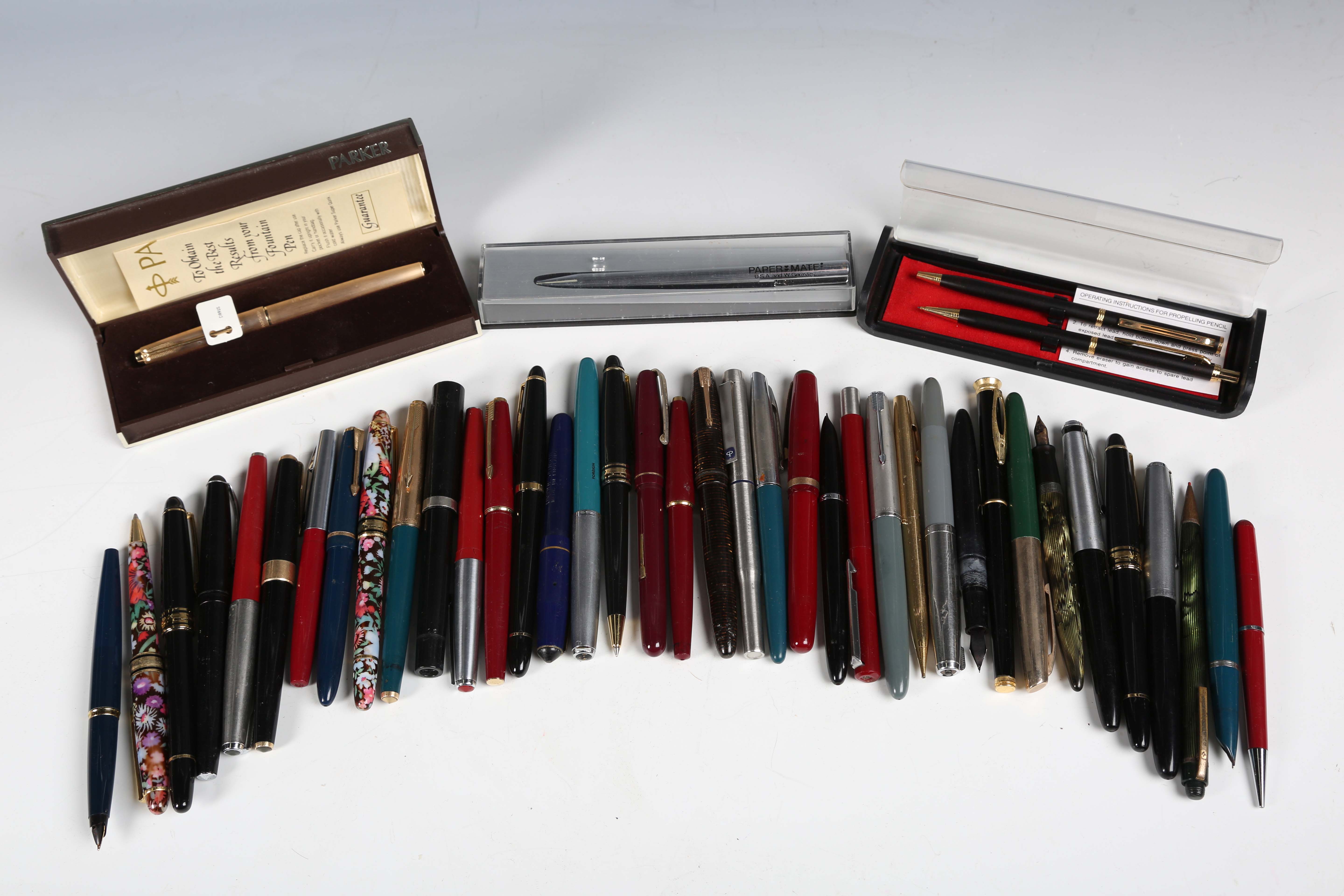 A collection of various fountain pens, ballpoints and pencils, including a Parker Duofold with