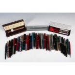 A collection of various fountain pens, ballpoints and pencils, including a Parker Duofold with