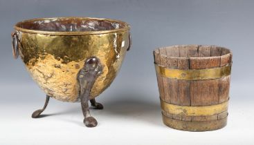 A late 19th century Arts and Crafts brass coal bucket with shaped steel feet, height 30cm,