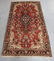 A Borchalue rug, North-west Persia, mid-20th century, the red field with a shaped medallion,