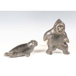 Two Inuit carved black stone figures, one modelled as an Inuit, height 19cm, the other as a