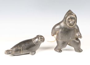 Two Inuit carved black stone figures, one modelled as an Inuit, height 19cm, the other as a