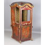 An 18th century North European rococo style giltwood framed and painted leather sedan chair, the