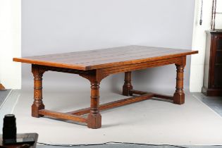 A modern 17th century style solid oak refectory dining table, raised on ring turned legs, height