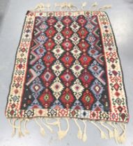 A Turkish kelim rug, late 20th century, the multi-coloured field with horizontal columns of