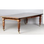 A late Victorian walnut extending dining table, raised on turned and fluted legs, height 75cm,