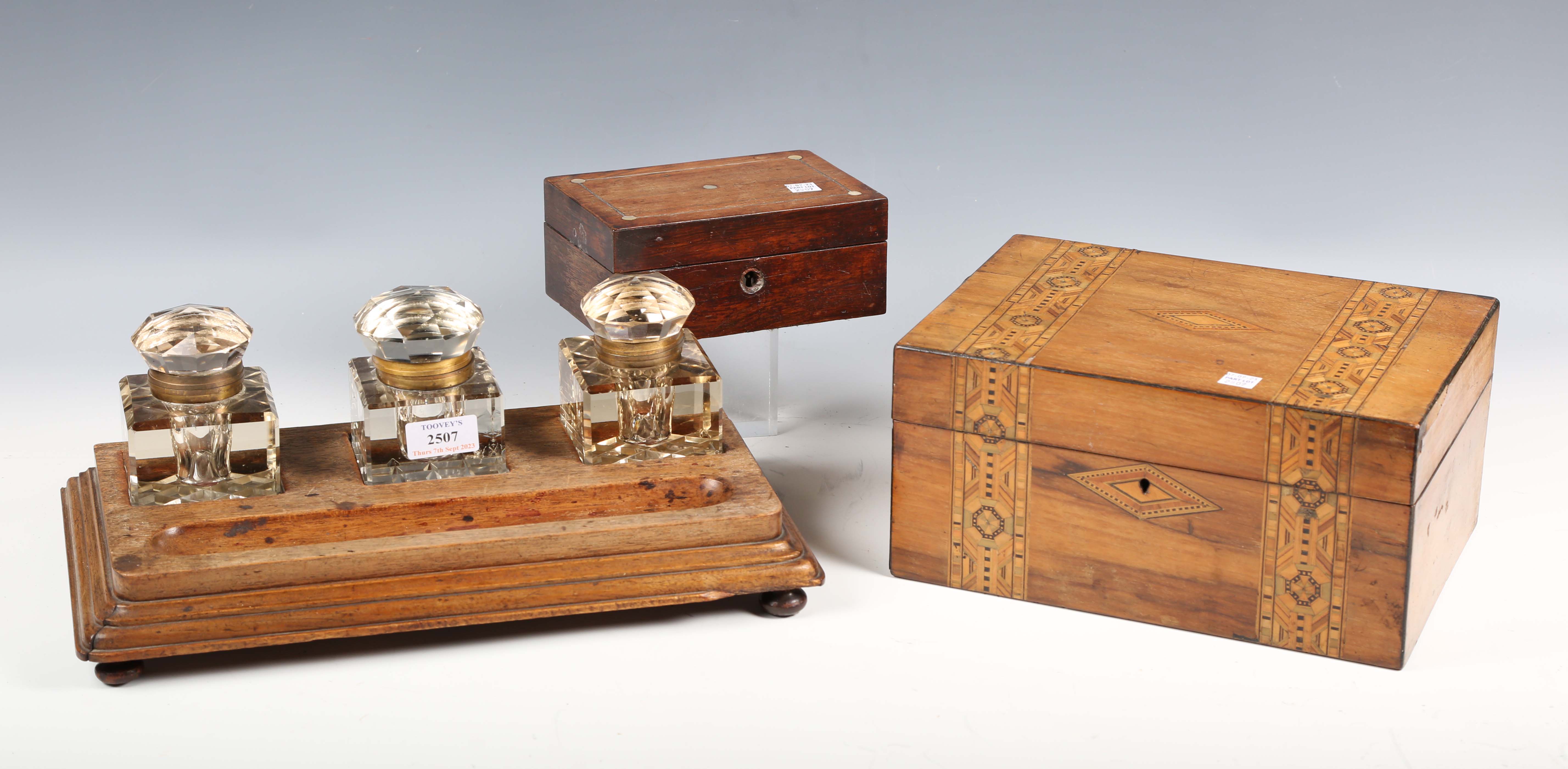 A late Victorian walnut desk stand, fitted with three glass inkwells, weight 38cm, together with two