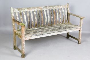 A 20th century wooden garden bench of slatted form, height 87cm, width 150cm, depth 57cm.Buyer’s