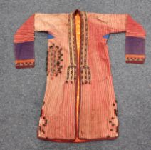 An early 20th century Turkoman coat with embroidered edging, a small naval pennant, an embroidered