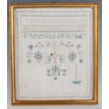 An early Victorian unfinished needlework sampler, dated 1841, partially worked with plants and