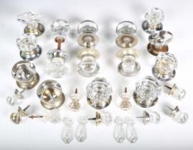 A collection of mainly late 19th century and early 20th century glass door handles and knobs.Buyer’s
