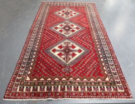 A Lori carpet, South-west Persia, mid/late 20th century, the red field with three ivory hooked