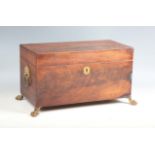 A Regency figured mahogany tea caddy with lion mask ring handles and claw feet, width 34cm.Buyer’s