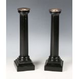 A pair of David Linley ebonized candlesticks with plated brass sconces and fluted columns,