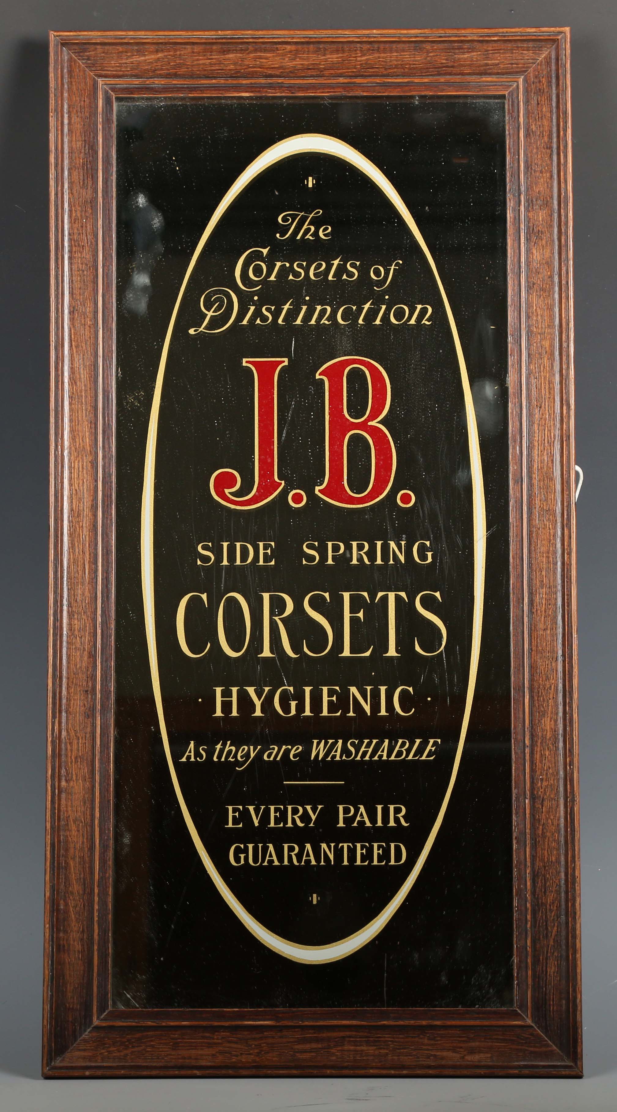 A late 19th/early 20th century J.B. Side Spring Corsets advertising mirror, within an oak frame,