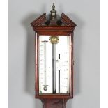 An early 19th century mahogany stick barometer, the silvered dial with Vernier scale and mercury