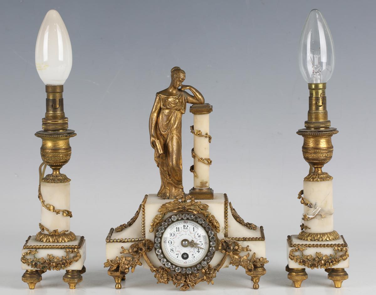 A late 19th century French ormolu mounted alabaster clock garniture, the timepiece with eight day