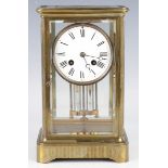 A late 19th century French brass four glass mantel clock with eight day movement striking on a bell,