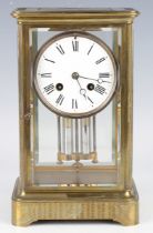 A late 19th century French brass four glass mantel clock with eight day movement striking on a bell,