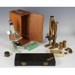 A lacquered brass monocular microscope, signed 'R & J Beck London 7979', with rack and pinion