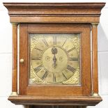 An early 18th century and later oak hood clock with thirty hour movement striking on a bell via an