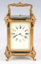 An early 20th century French lacquered brass cased carriage clock with eight day movement striking