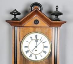 A late 19th century walnut and ebonized Vienna style wall timepiece with single train movement,