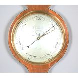A George III mahogany wheel barometer with silvered dials and alcohol thermometer, signed '