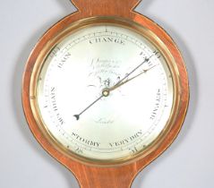 A George III mahogany wheel barometer with silvered dials and alcohol thermometer, signed '