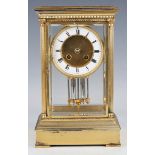 An early 20th century lacquered brass four glass mantel clock, the eight day movement striking on