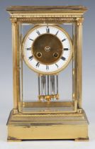 An early 20th century lacquered brass four glass mantel clock, the eight day movement striking on