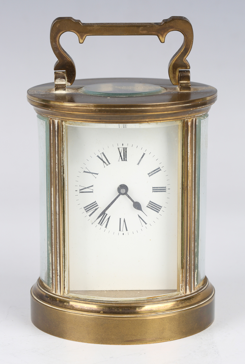 An early 20th century brass circular carriage timepiece with eight day movement, the backplate
