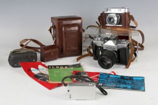 A small group of cameras and accessories, including a Microflex twin lens reflex camera with leather