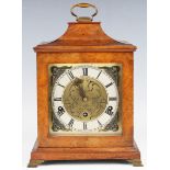 A 20th century walnut mantel clock with eight day movement chiming on gongs, the backplate