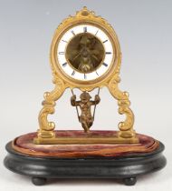 A late 19th century French brass mantel timepiece with eight day movement, the white enamelled