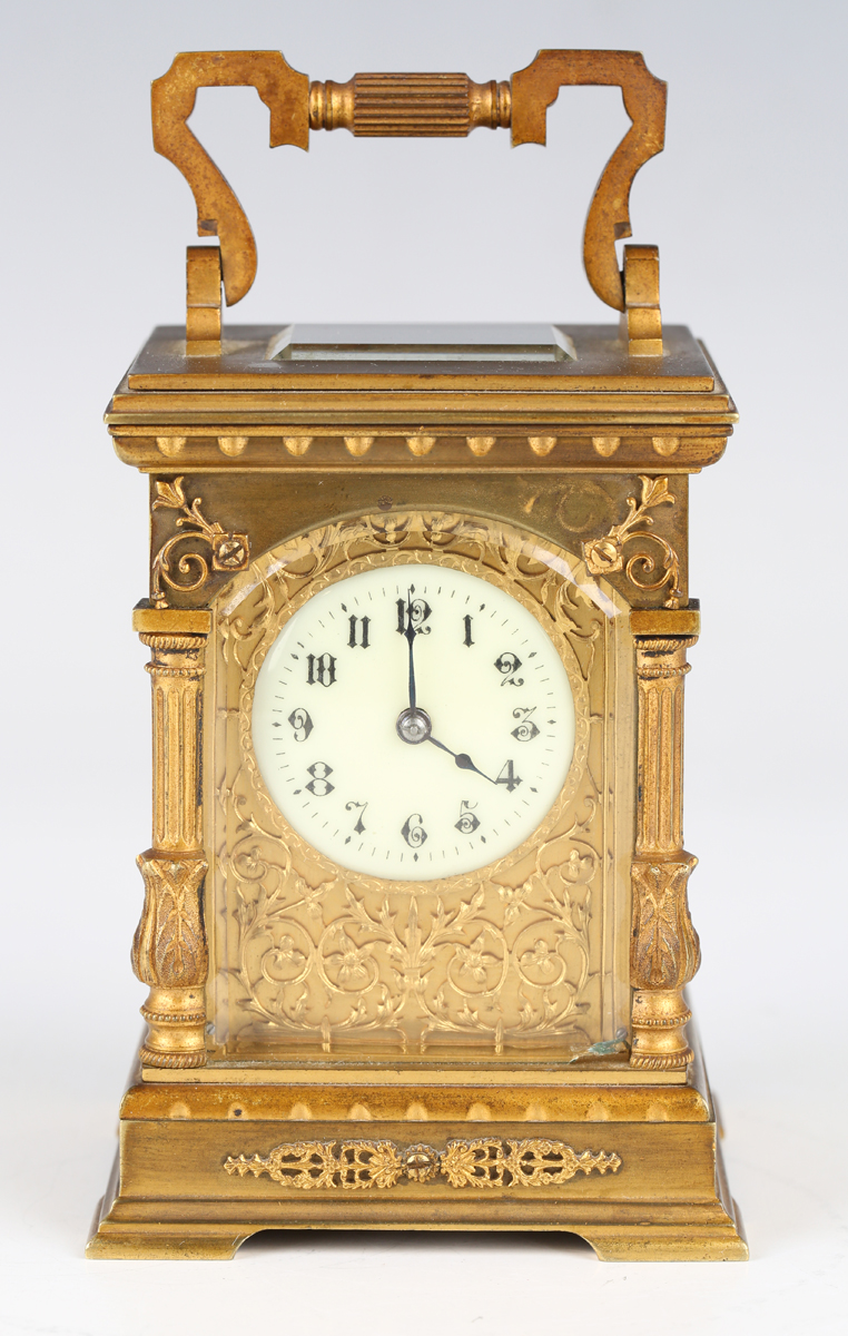 A late 19th/early 20th century French lacquered brass cased carriage timepiece with eight day