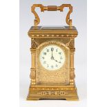 A late 19th/early 20th century French lacquered brass cased carriage timepiece with eight day