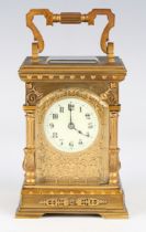 A late 19th/early 20th century French lacquered brass cased carriage timepiece with eight day