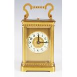 A late 19th/early 20th century gilt lacquered brass carriage clock with eight day movement