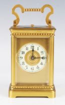 A late 19th/early 20th century gilt lacquered brass carriage clock with eight day movement